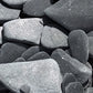 Close-up of dry black tumbled slate gravel 30-50mm showing natural texture and colour variation, ideal for decorative UK garden landscaping.