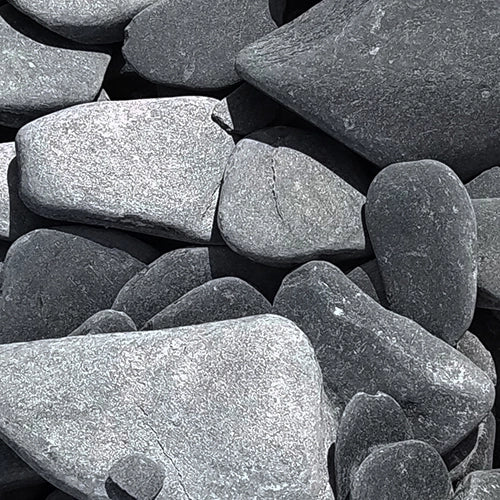 Close-up of dry black tumbled slate gravel 30-50mm showing natural texture and colour variation, ideal for decorative UK garden landscaping.