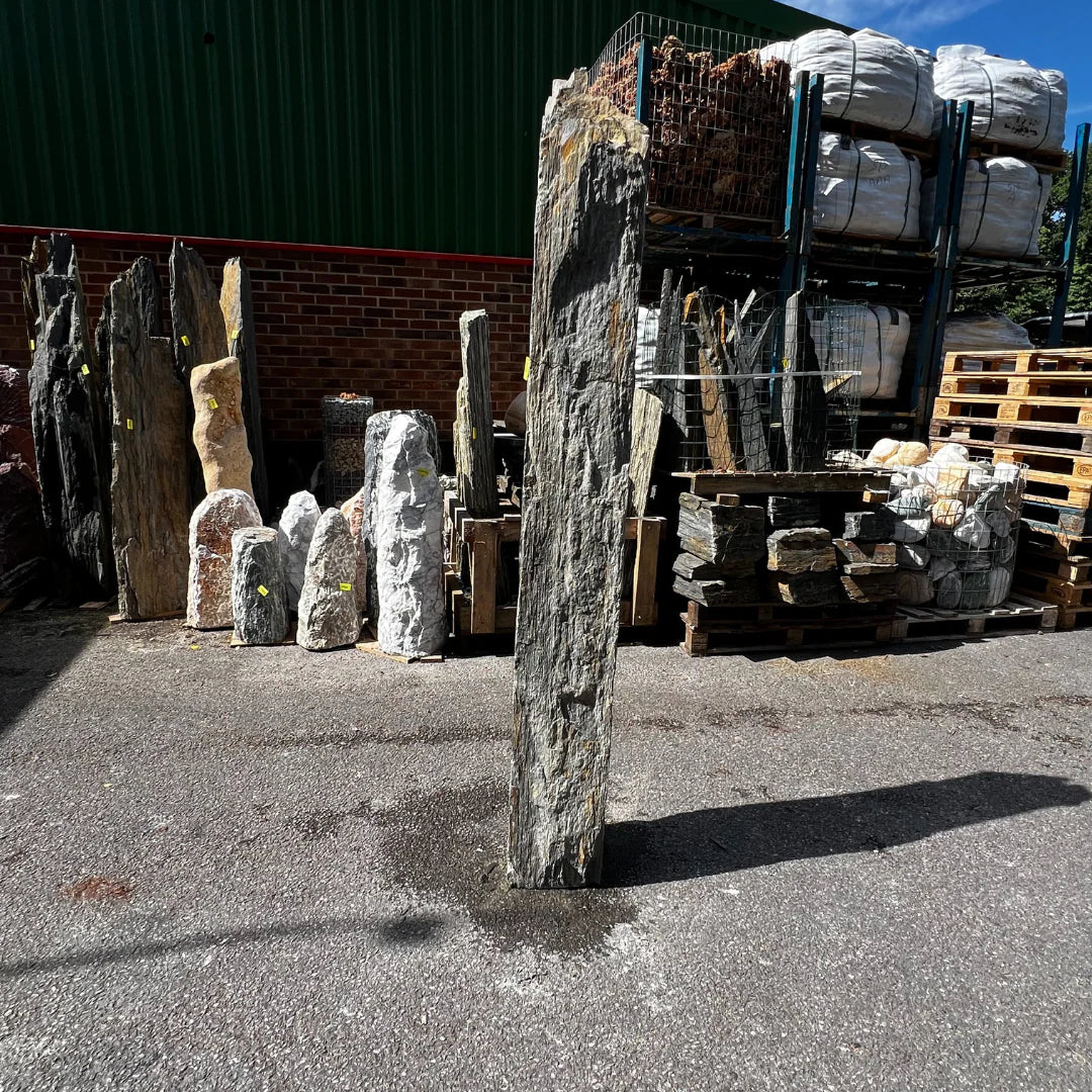 Outdoor monolith stone decor for UK gardens, crafted from natural rock with rustic tones and vertical form.