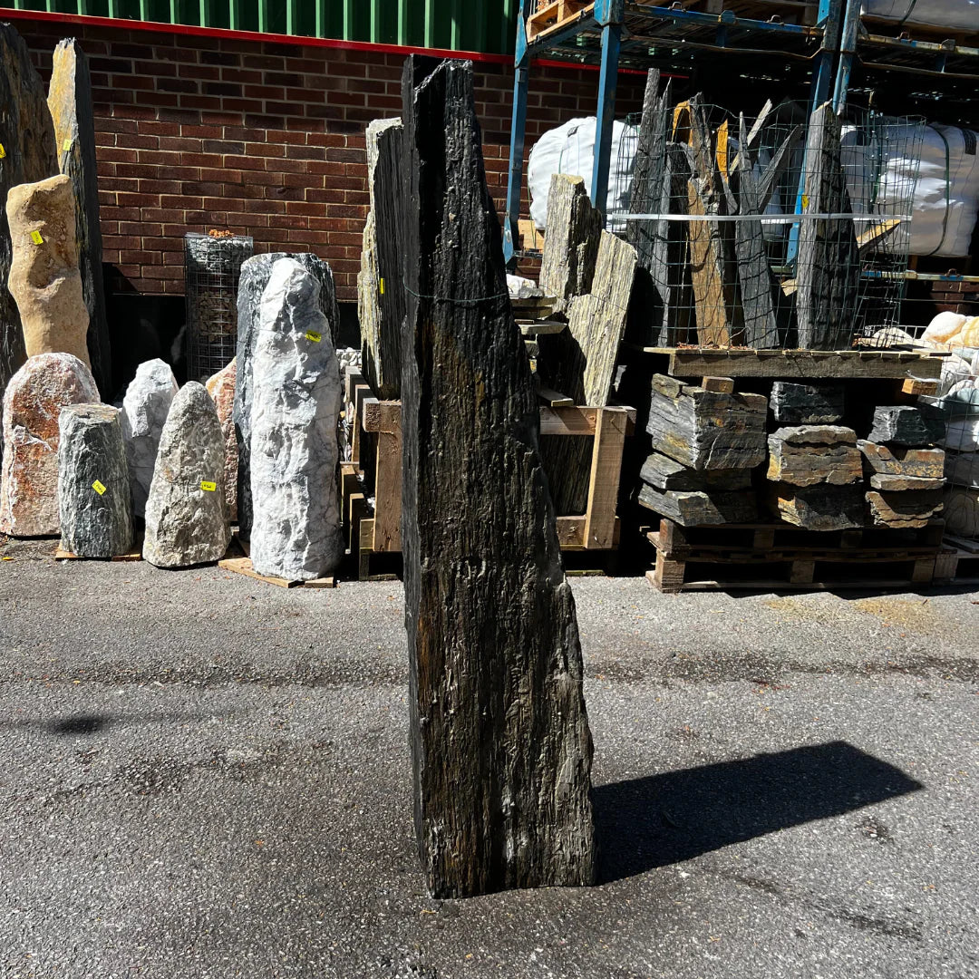 Decorative landscape monolith carved from natural stone, perfect for adding a timeless outdoor feature to gardens.