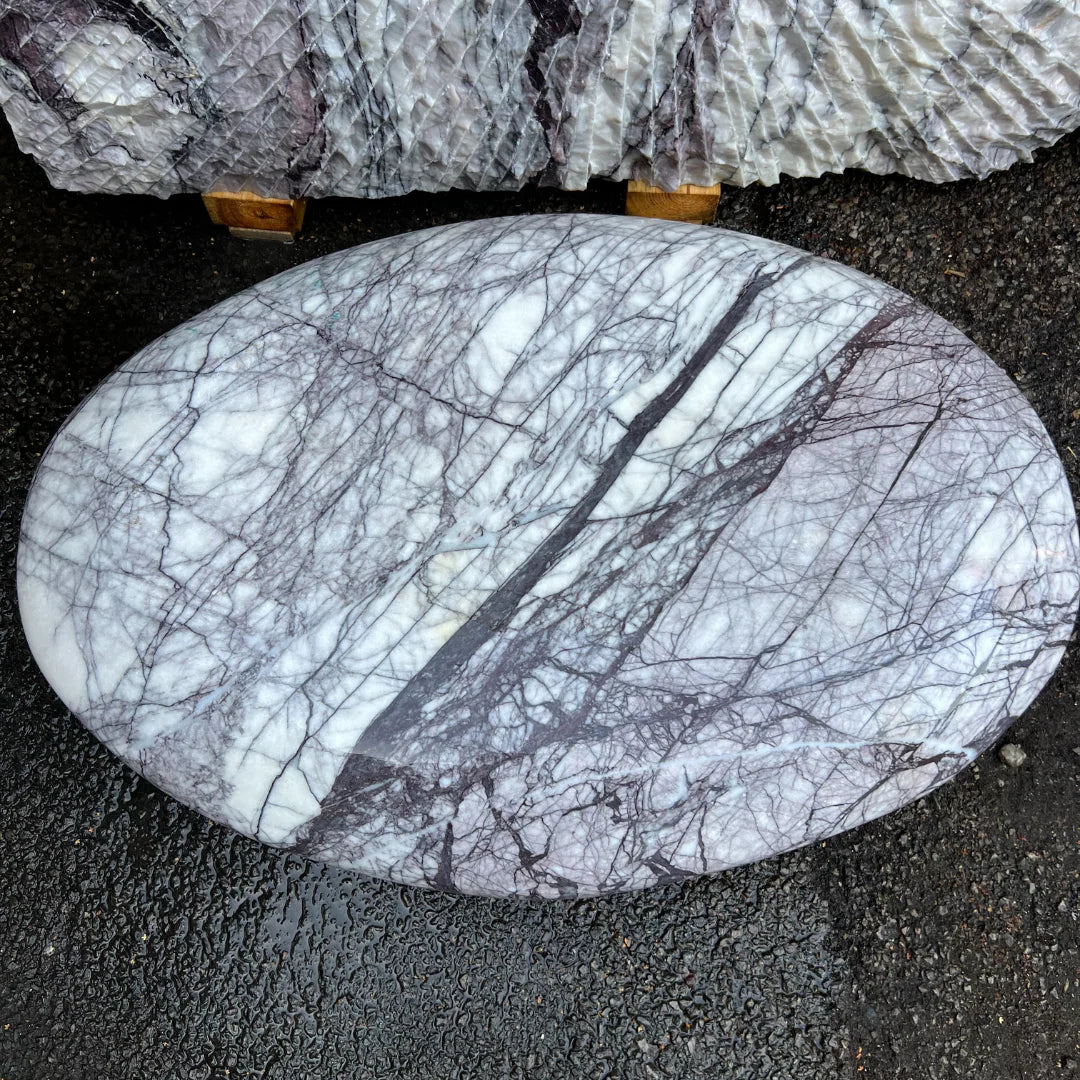 Decorative marble stone monolith with soft veined surface, enhancing outdoor gardens and gravel landscapes.