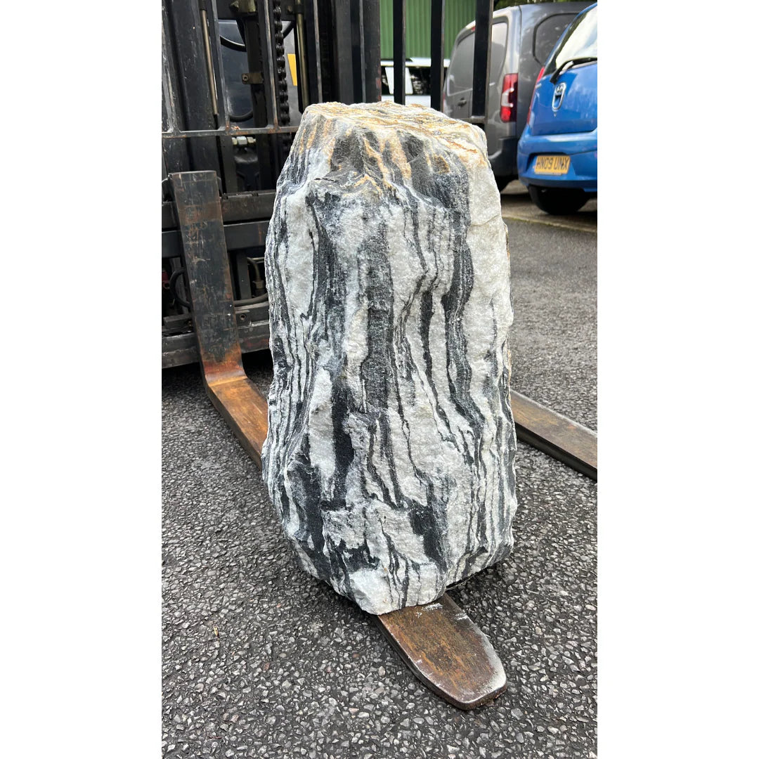 Decorative garden stone monolith with white and black streaks, showcased outdoors at Stones4Gardens.