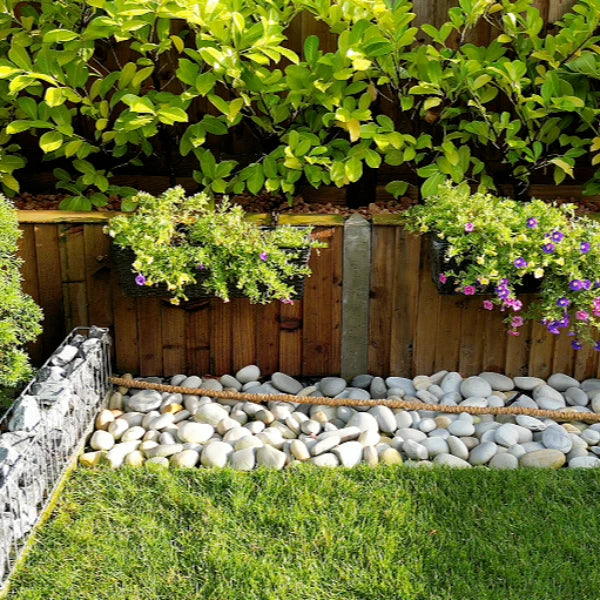 our garden stones in our customers garden, using our porto pebbles and gabion border with Kronos pebbles.