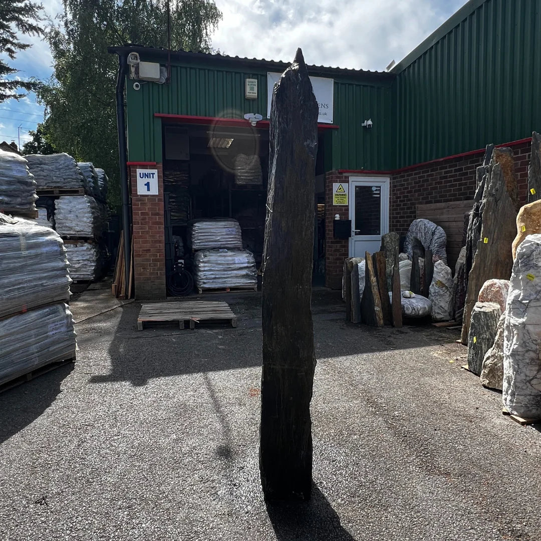 Natural stone monolith garden feature in earthy tones, complementing pebbles, gravel, and rockery layouts.