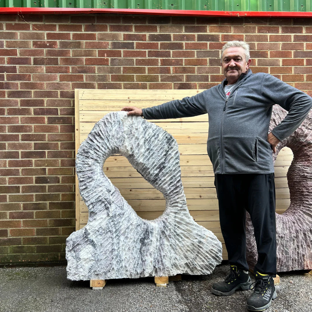 Italian marble monolith sculpture with refined Leylak pattern, offering sophistication and natural beauty to landscaped gardens.