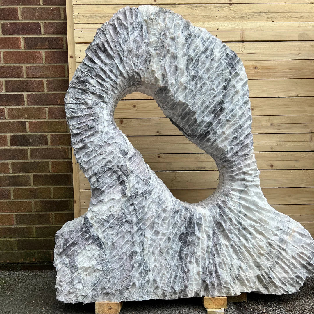 Close-up of Leylak marble monolith surface, displaying detailed veining and smooth textures ideal for premium garden décor inspiration.