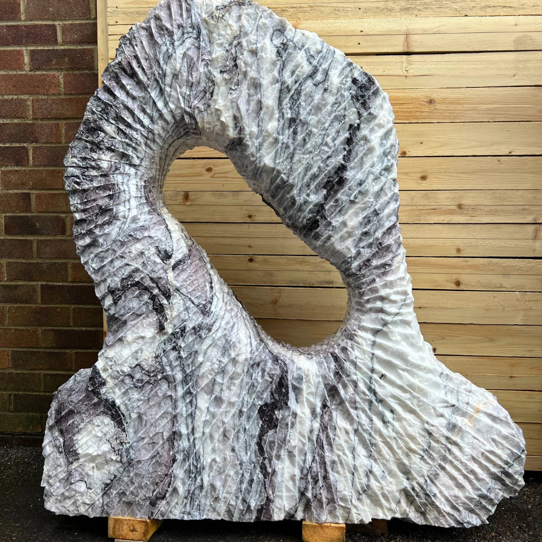 Luxury marble stone monolith MON-052S used as an outdoor sculpture, blending artful Italian design with timeless garden elegance.