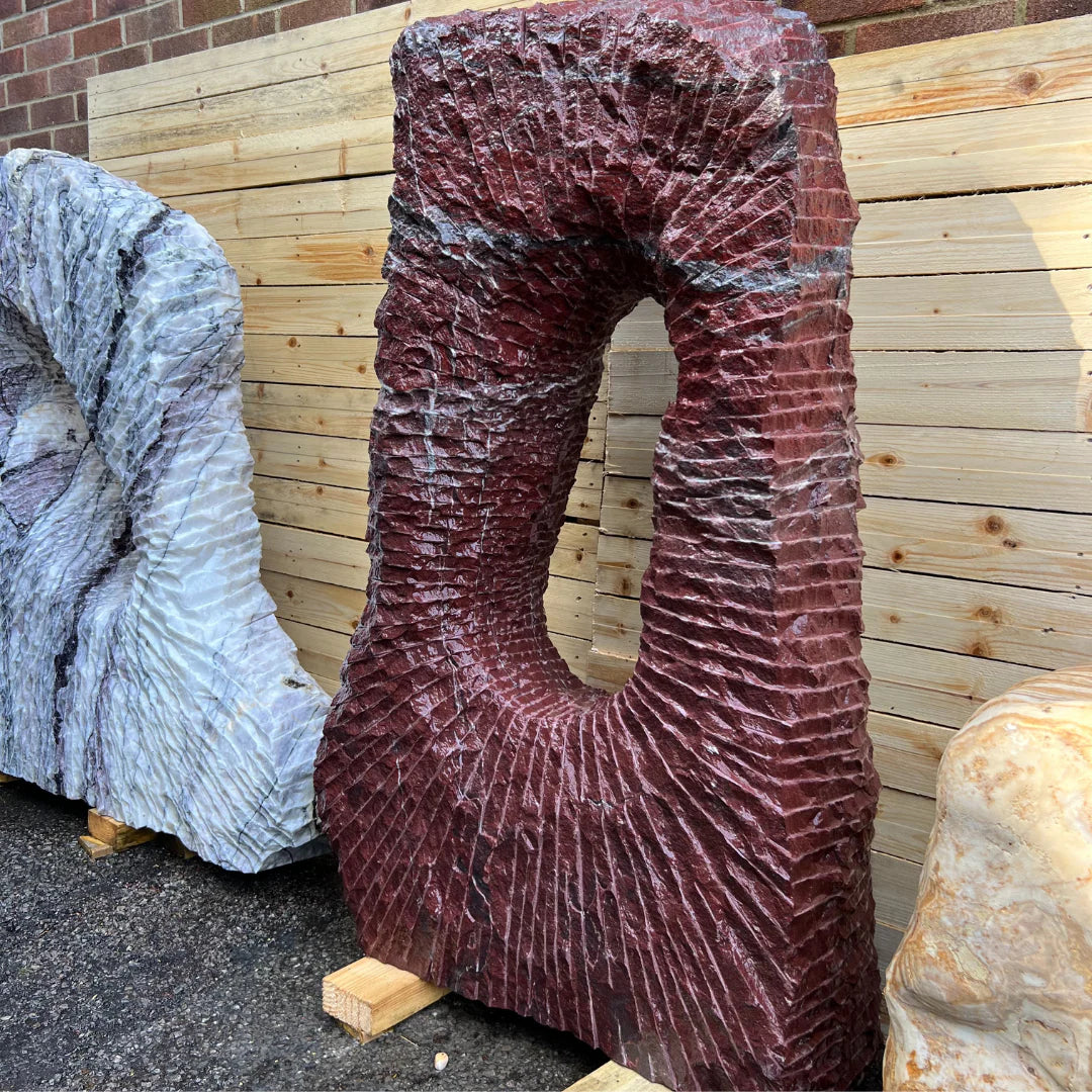 Flamingo natural stone monolith with pink and white tones, sculpted for UK gardens and outdoor stone displays.