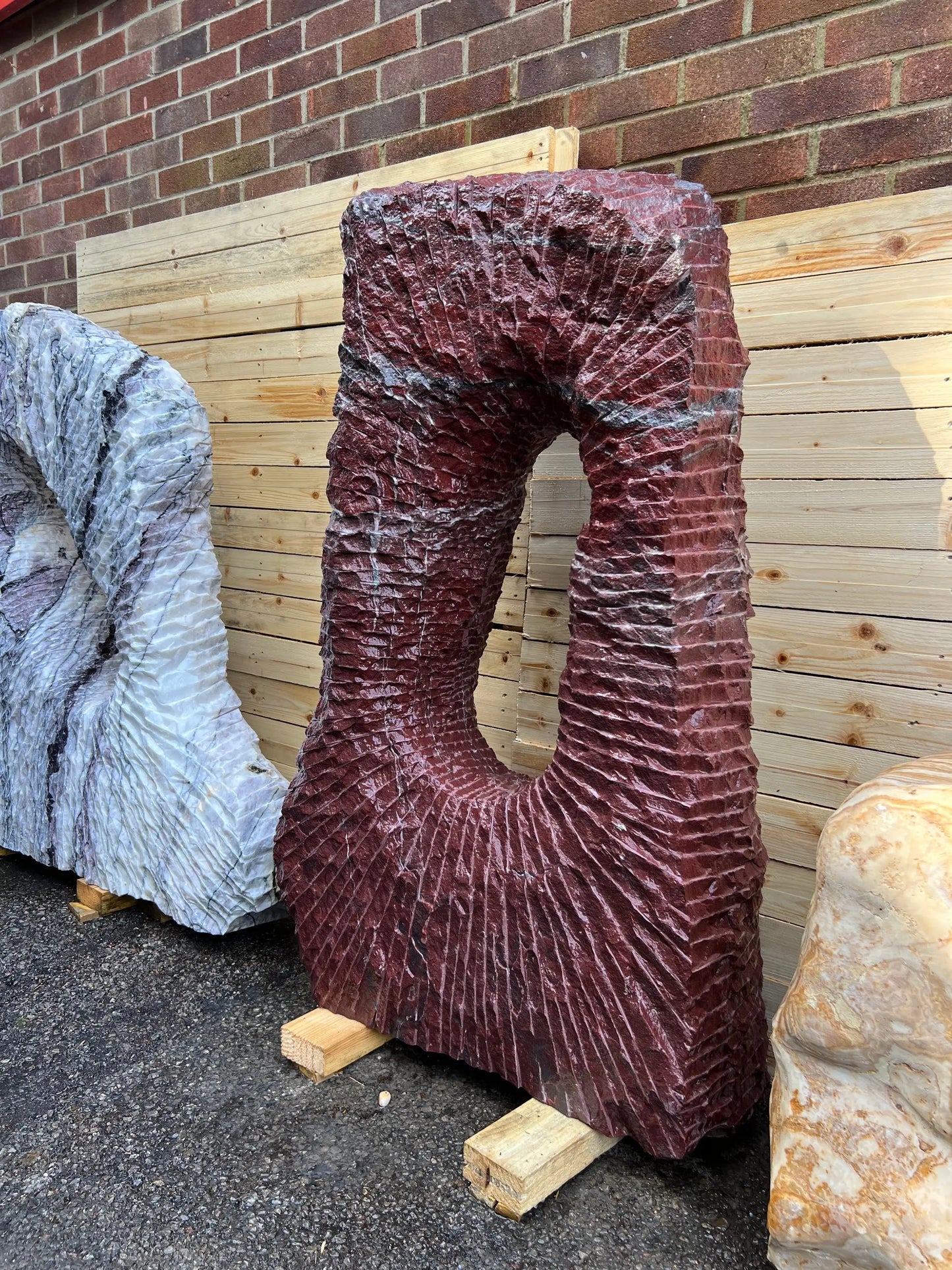 Natural Onyx stone monolith for UK gardens, combining raw stone texture with smooth flamingo-inspired colour tones.