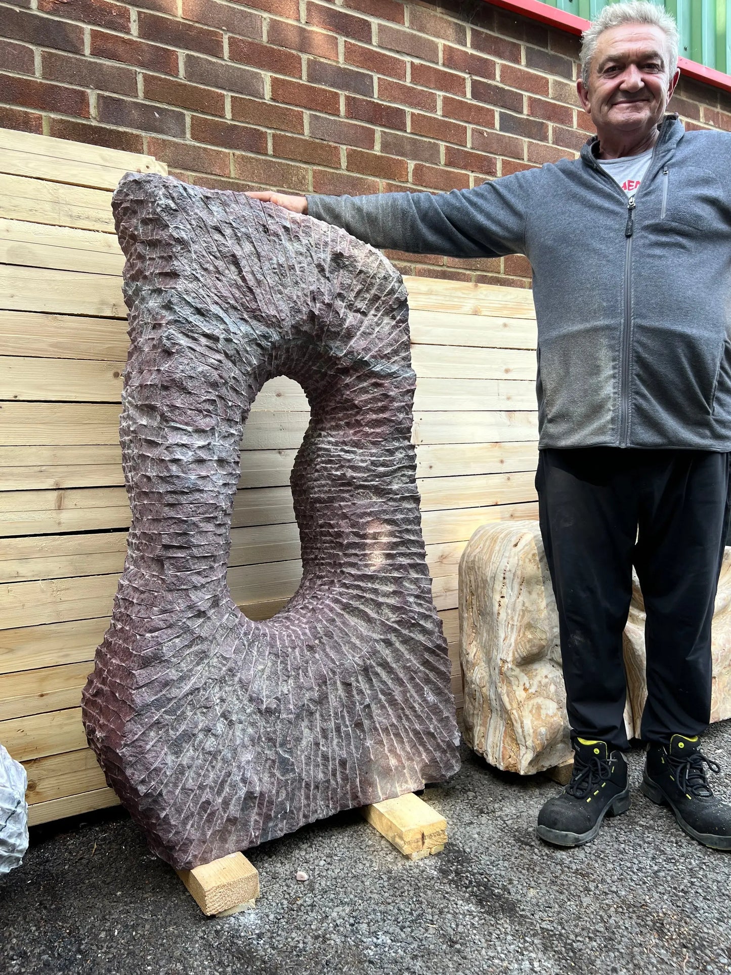 Outdoor decorative monolith carved from Onyx, pairing perfectly with garden gravel, stones, and pebble pathways.