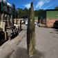 Natural stone monolith used as a landscape feature in UK gardens, blending beauty with raw geological texture.