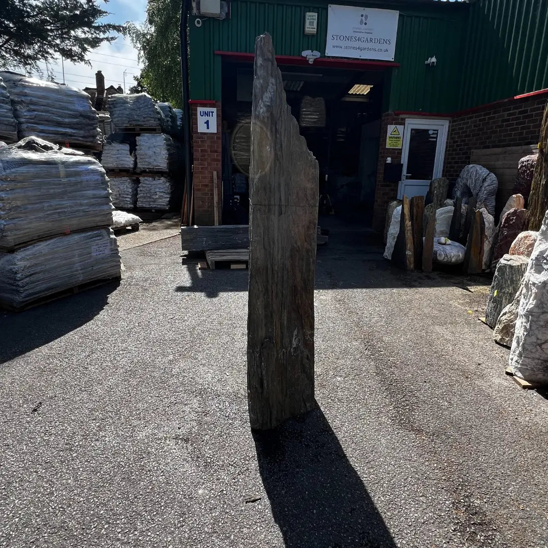 Outdoor garden monolith made from durable natural stone, ideal for gravel and pebble landscape designs.