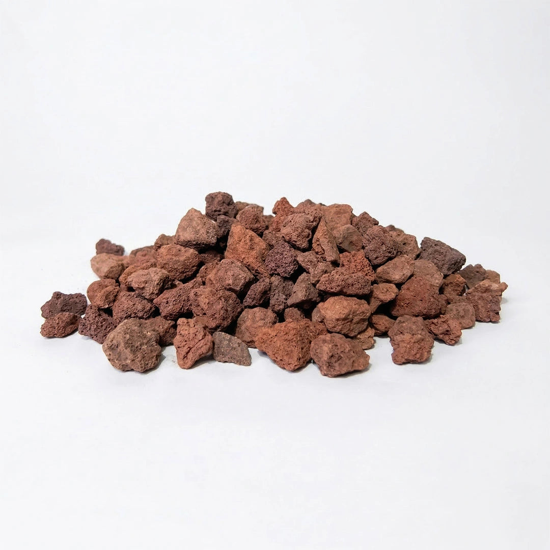 Red lava gravel stones in a loose pile on a plain background