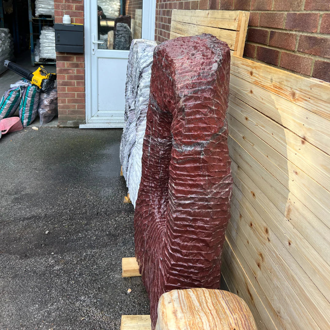 Decorative garden stone sculpture made from Onyx, ideal as a centerpiece among garden pebbles and gravel.