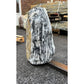 Grey and white striped stone monolith adding contrast and texture to landscaped garden areas.