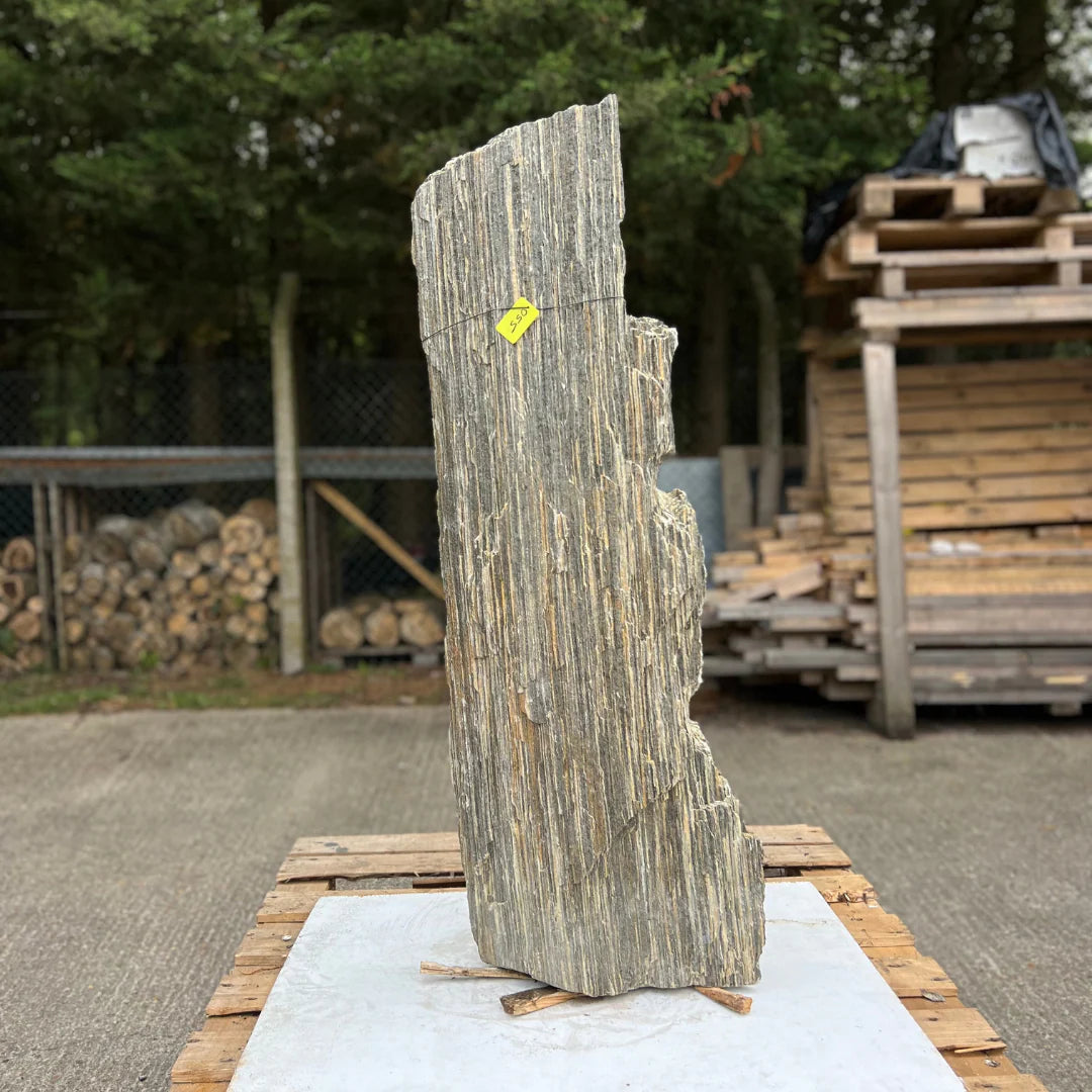 Tall natural garden monolith MON-055 with layered stone texture, ideal as a centrepiece for modern outdoor landscapes.