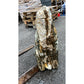 Tall outdoor monolith crafted from natural stone, adding height and texture to landscaped garden areas.