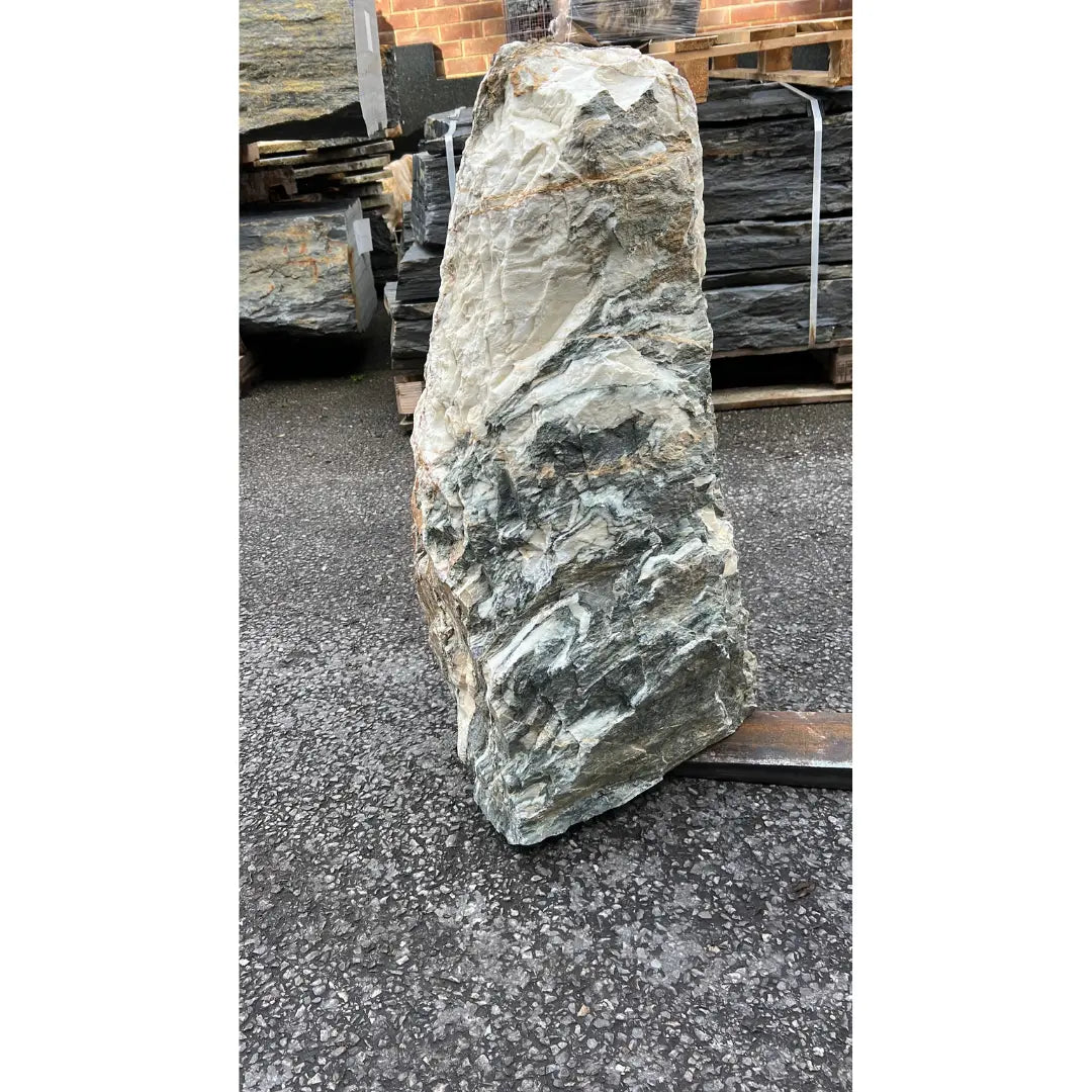 Unique natural stone monolith with distinctive gold and grey streaks, enhancing decorative outdoor spaces.