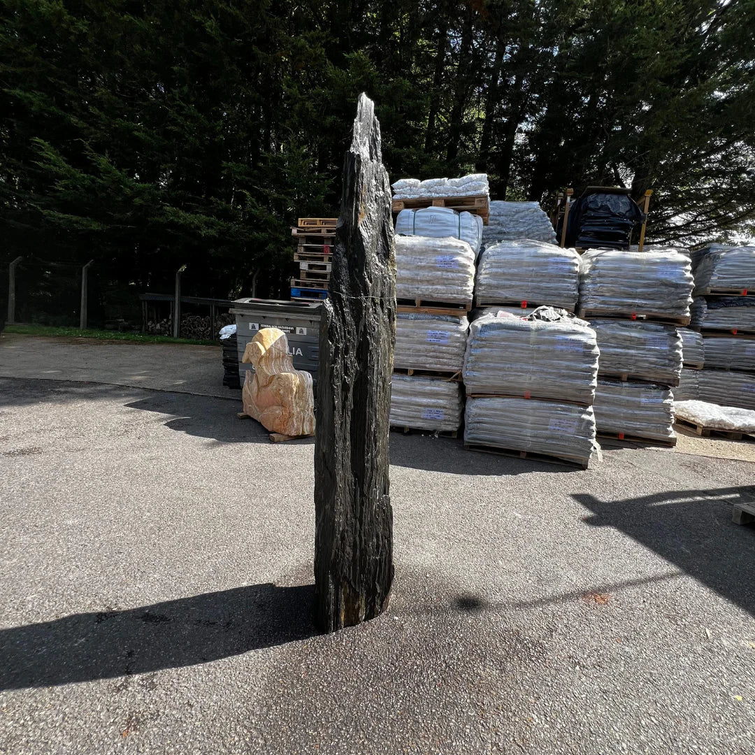 Weathered stone monolith with slim profile and natural finish, ideal for decorative garden and outdoor installations.