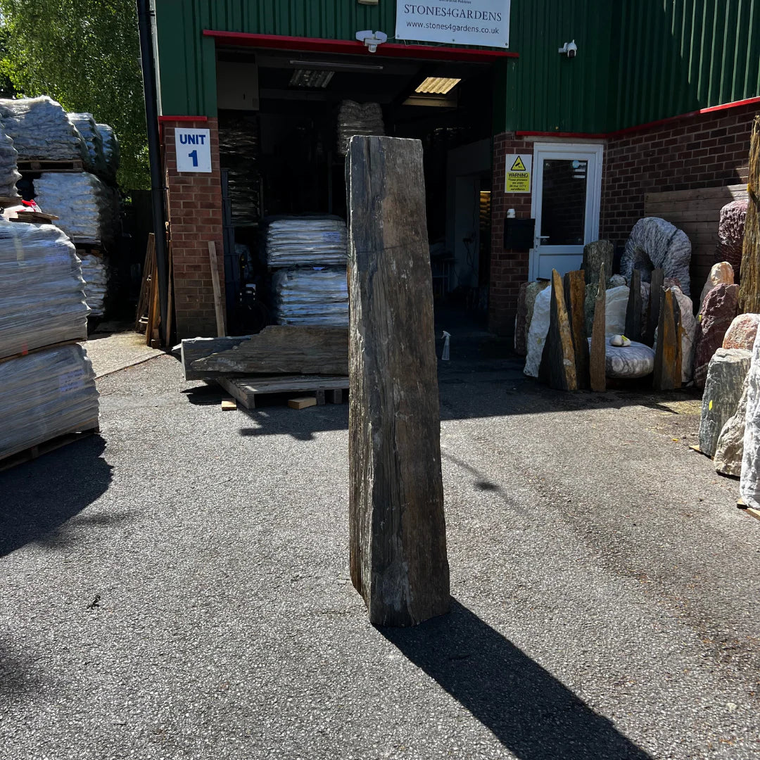 Weathered natural stone monolith showcased by Stones4Gardens, perfect for gravel and pebble landscaping projects.